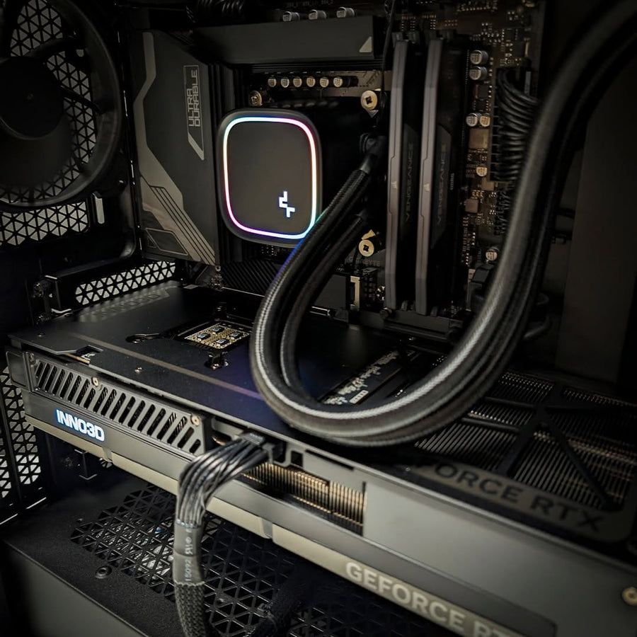 Close up of an NVIDIA GeForce RTX 5080 graphics card installed inside a Ballista gaming PC with liquid CPU cooling.