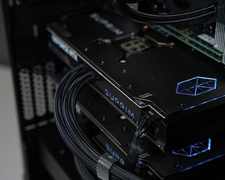 Close up of an NVIDIA GeForce RTX 5090 graphics card and power cables installed inside a Ballista gaming PC.