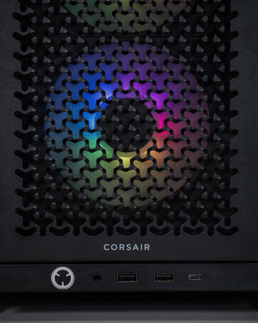 Close up of the Ballista PC front panel, highlighting the high airflow Corsair mesh design with RGB lighting behind it.