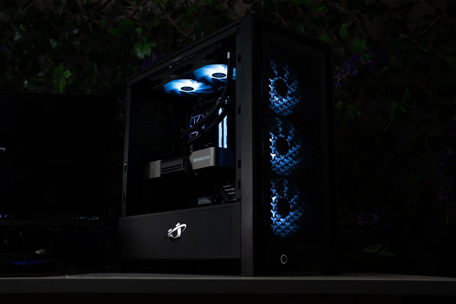 Ballista gaming PC in a low light setting, showing internal lighting and front cooling fans through the airflow focused case.