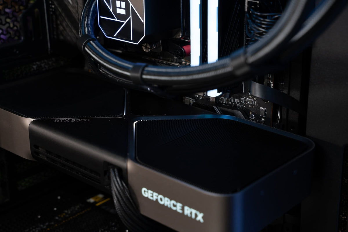 Close up inside a Ballista gaming PC showing a GeForce RTX 5080 graphics card, liquid cooling and internal space for future upgrades.