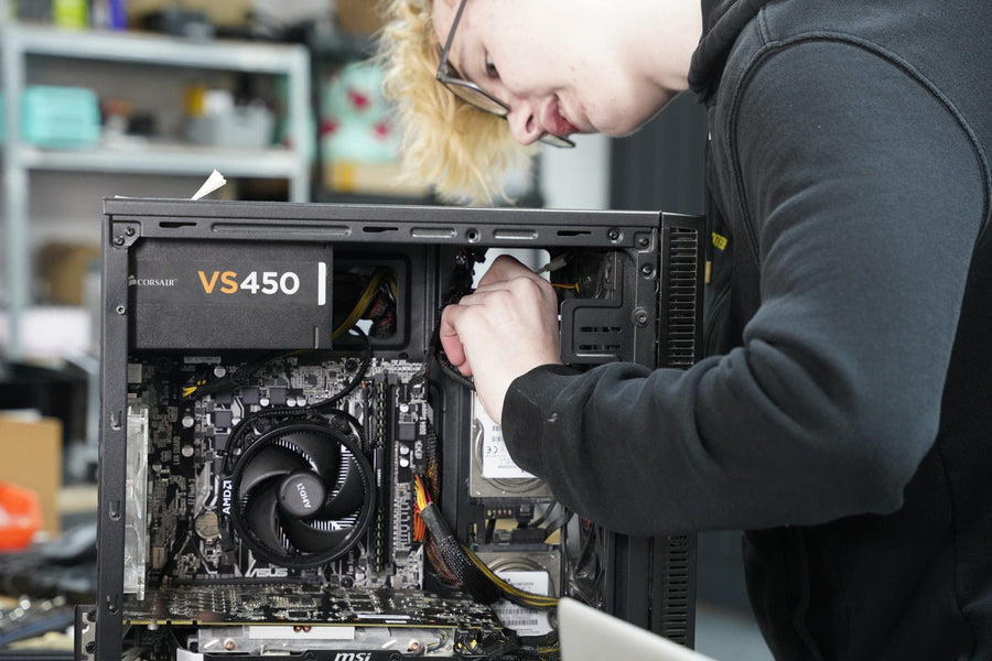 Utopia Computers technician repairing a desktop PC in the Kilmarnock workshop.