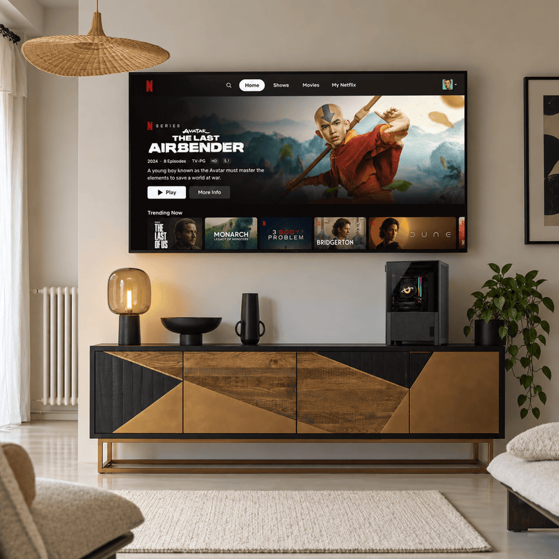 Pandora compact gaming PC on a living room media unit beneath a wall mounted